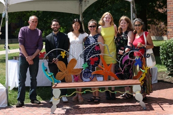 From left: artist Paul Knoblauch stands with the family of Tristram Smith, Ph.D.
