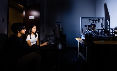 Liset Guaman-Correa (center), works with bench mentor Sanjana Kapisthalam in The Active Perception Lab. (Image captured in July 2021).