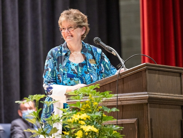 School of Nursing dean Kathy Rideout smiling on stage at pinning