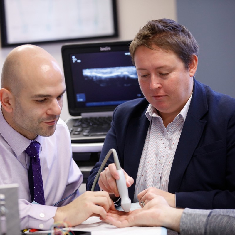 Hand surgeon Constantinos Ketonis, MD, and research scientist Alayna Loiselle, PhD, study tendon healing in the hand.