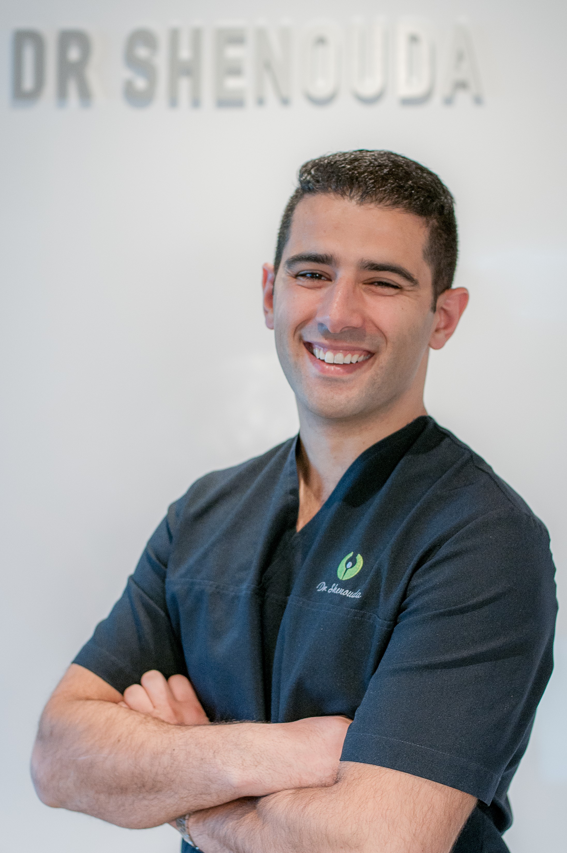 Andre Shenouda standing against the wall at his private practice