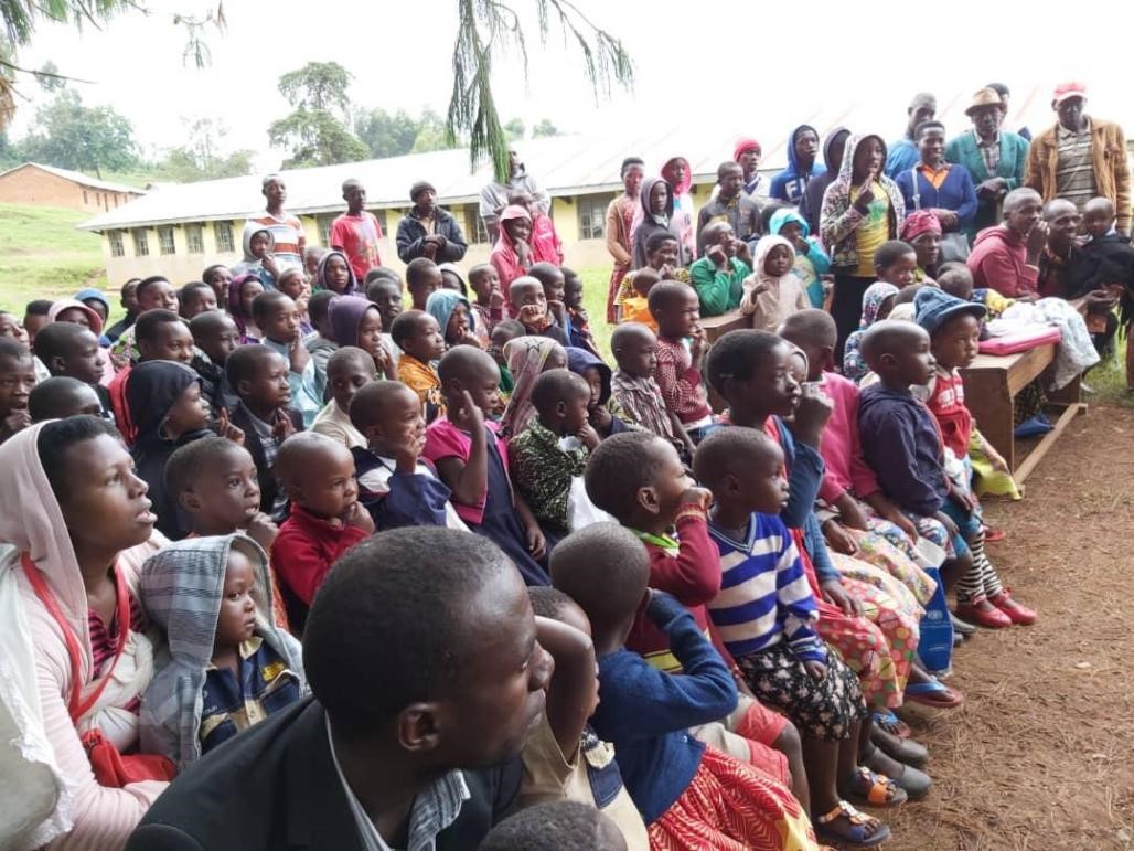 Large group of people sitting together listening to presentation