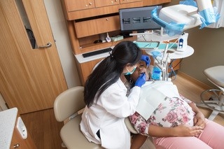 Dr. Xiao treating a pregnant patient at Eastman Dental