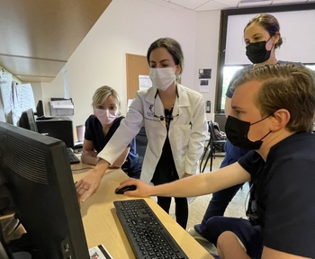 Periodontics faculty teaching a group of residents
