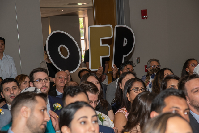 audience members holding up O F P balloons