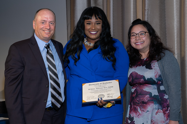 A Pediatric Dentistry resident poses with the department chair and program director.