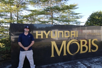 Dylan Colunio standing outside of his employer Hyundai Mobis
