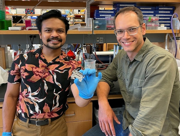 UR graduate student Azmeer Sharipol stands next to Wilmot scientist Ben Frisch in a medical laboratory at the Wilmot Cancer Institute