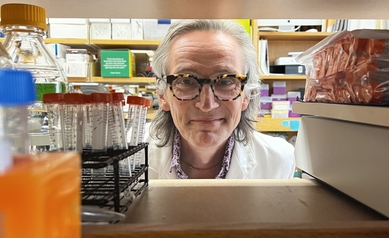 Dr. Dewhurst looking through shelves in lab