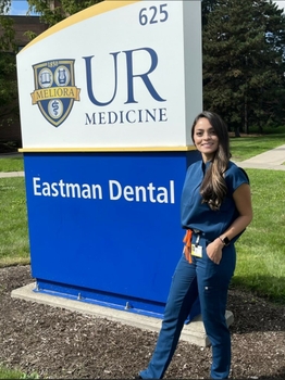 Raquel Cantillo outside next to Eastman Dental sign