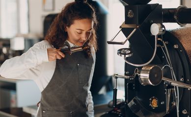 Coffee roaster machine and barista smell with tryer at coffee roasting process