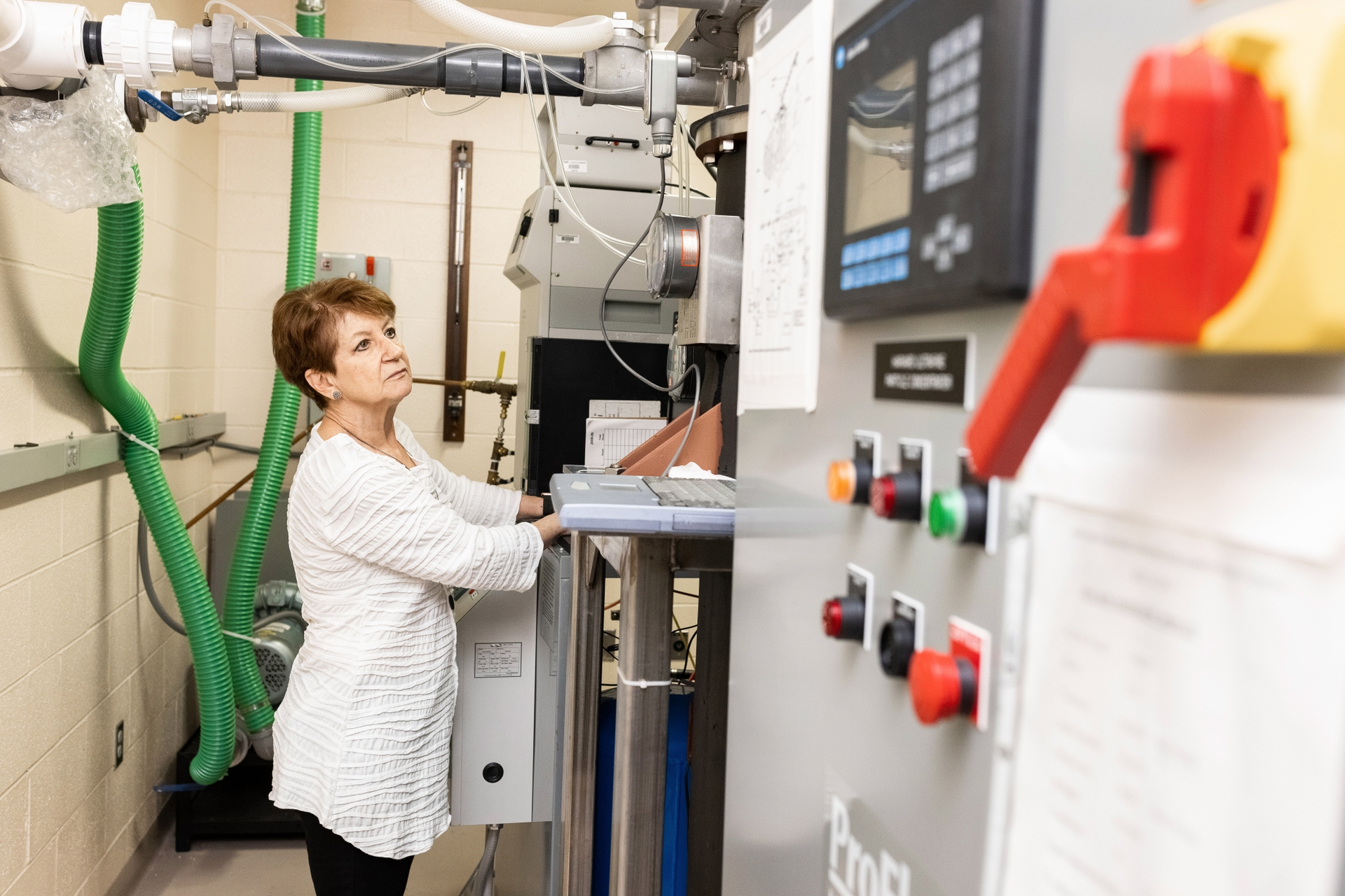 Debbie Cory-Slechta, PhD, checks the Harvard Ultrafine Concentrated Ambient Particle System (HUCAPS). HUCAPS takes in the outside air to be studied in real time. It is one of only a handful in use in the United States.