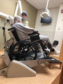 patient in wheelchair lift at Eastman Dental 
