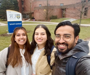 Dr. Ahmed standing outside Eastman building with co residents