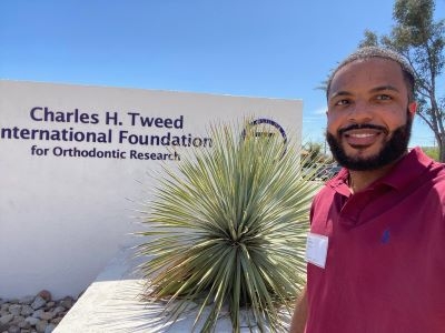 Dr. Morgan in front of sign