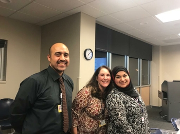 Linda Lipani is smiling in between Mohammed and Furqan
