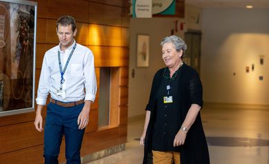From left: Samuel Mackenzie, MD, PhD, and Emma Ciafaloni, MD, walk together in the Golisano Children's Hospital.