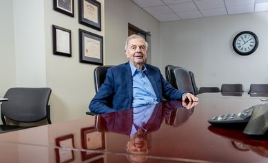 Robert Griggs, MD, at table in Garvey Room at Strong Memorial Hospital.
