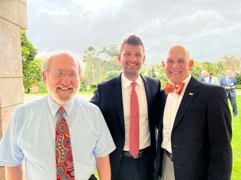 Three men in ties stand together