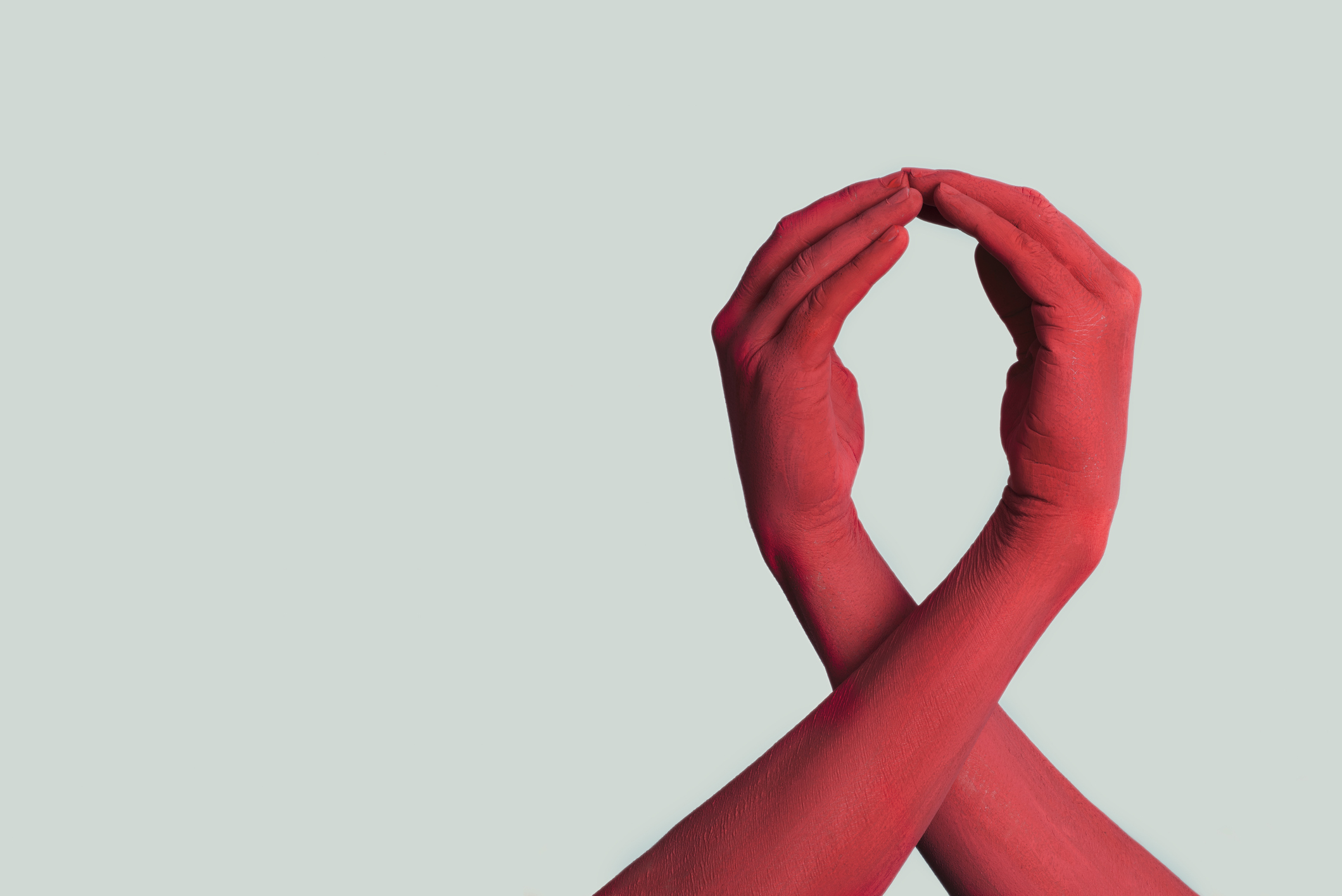 red ribbon formed by red painted hands