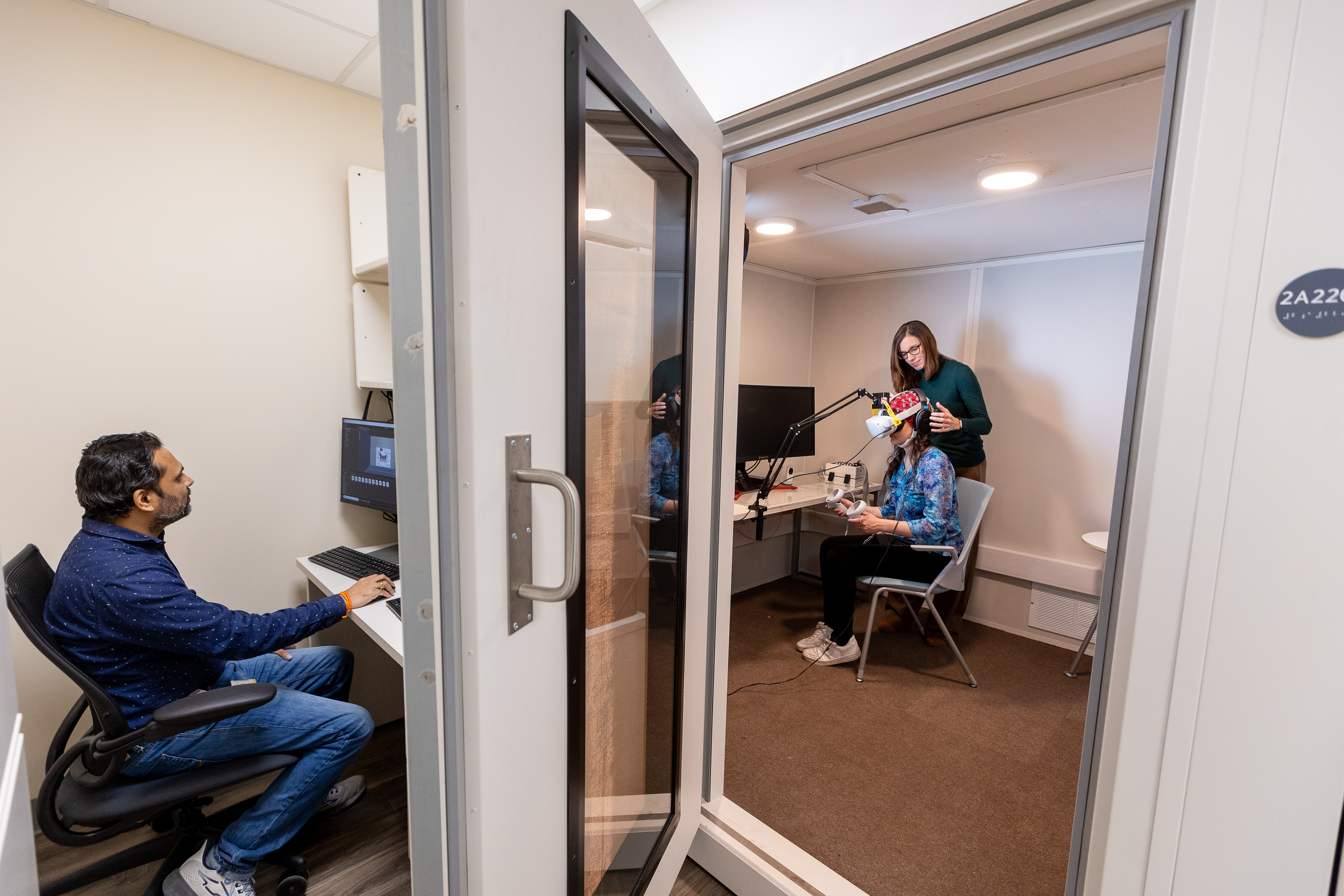 Emily Knight, MD, PhD, and lab technician Nishant Joshi Dinesha collect EEG data from subject in the Spectrum Brain Lab in CABIN.