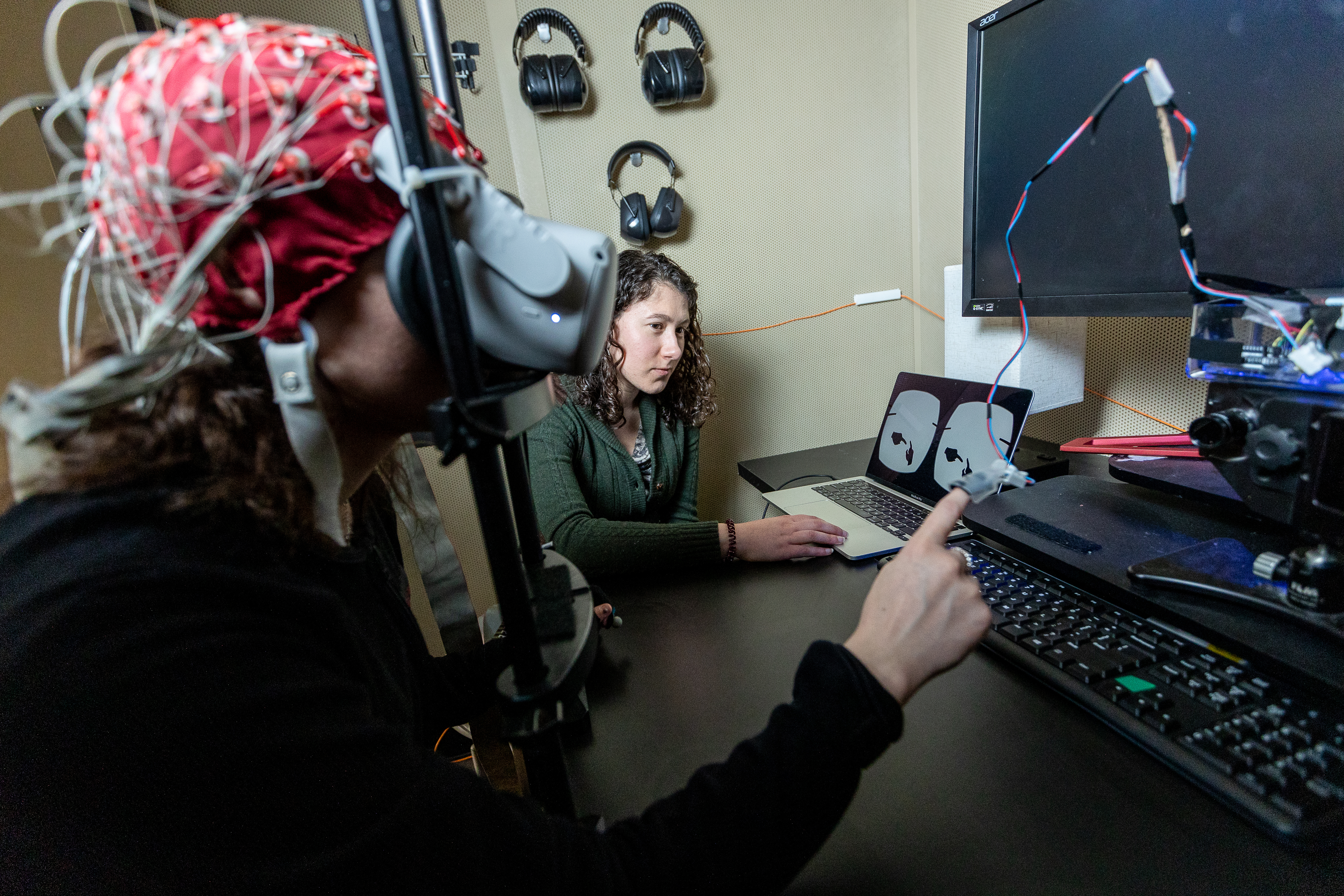 MD/PhD student Emily Isenstein (right) is with a subject in EEG booth in CABIN. Isenstein is using new advancements to understand how the brain responds to active and passive touch. This could improve therapies for people with autism that could make passive touch less unpleasant.