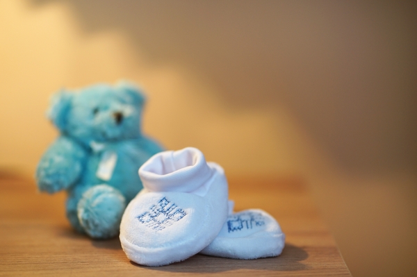 Baby shoes and teddy bear