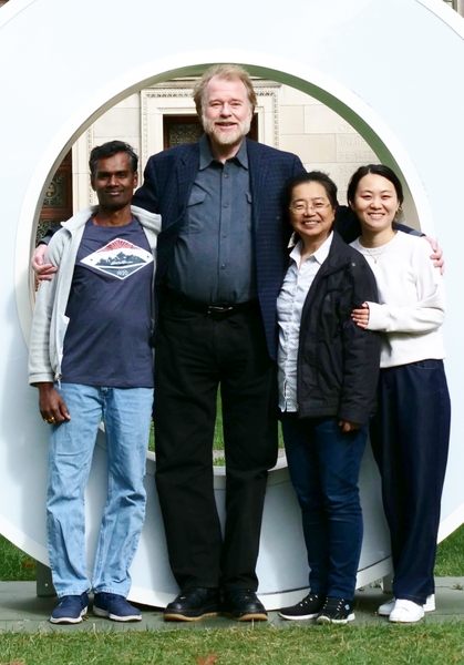 Four people standing side-by-side