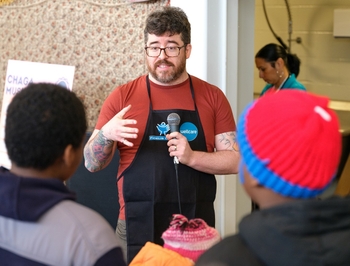 Isaac Harris talking to community at Rochester Public Market - 2024