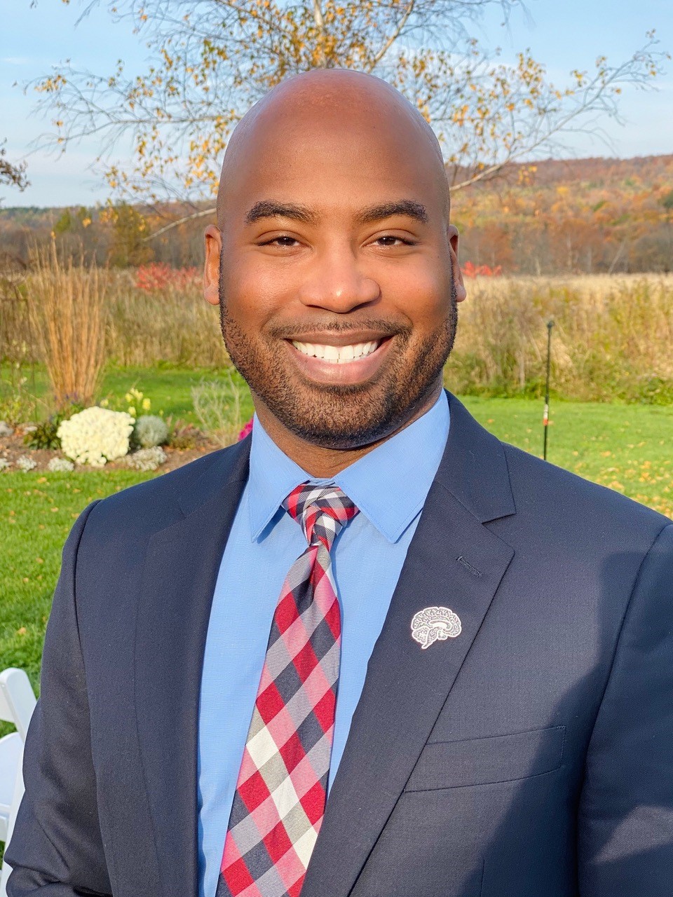 Nathan A. Smith PhD, wearing blue blazer and blue shirt.
