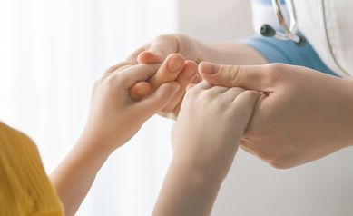 hero image - childs hands with doctor
