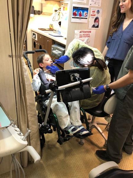 Student from Mary Cariola receives dental care from the SMILEmobile, part of Eastman Institute for Oral Health.