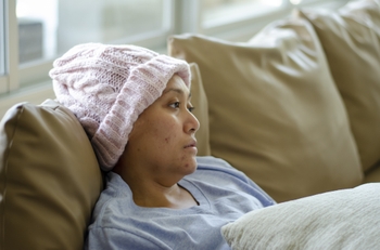 sad cancer patient on couch looking off