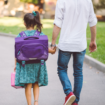 Adult walking a child to school