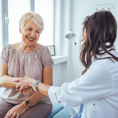 Hand of doctor reassuring her female patient.