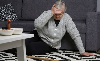 falls prevention woman on floor with cane
