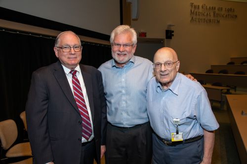Dr Tabak standing with friends looking at camera