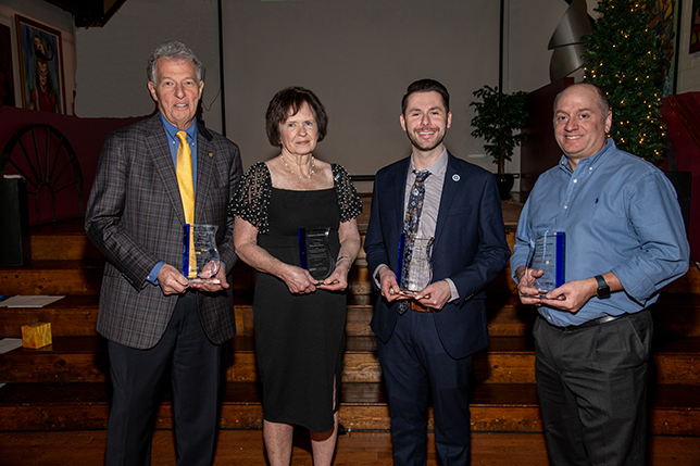 award winners standing and looking at camera at event