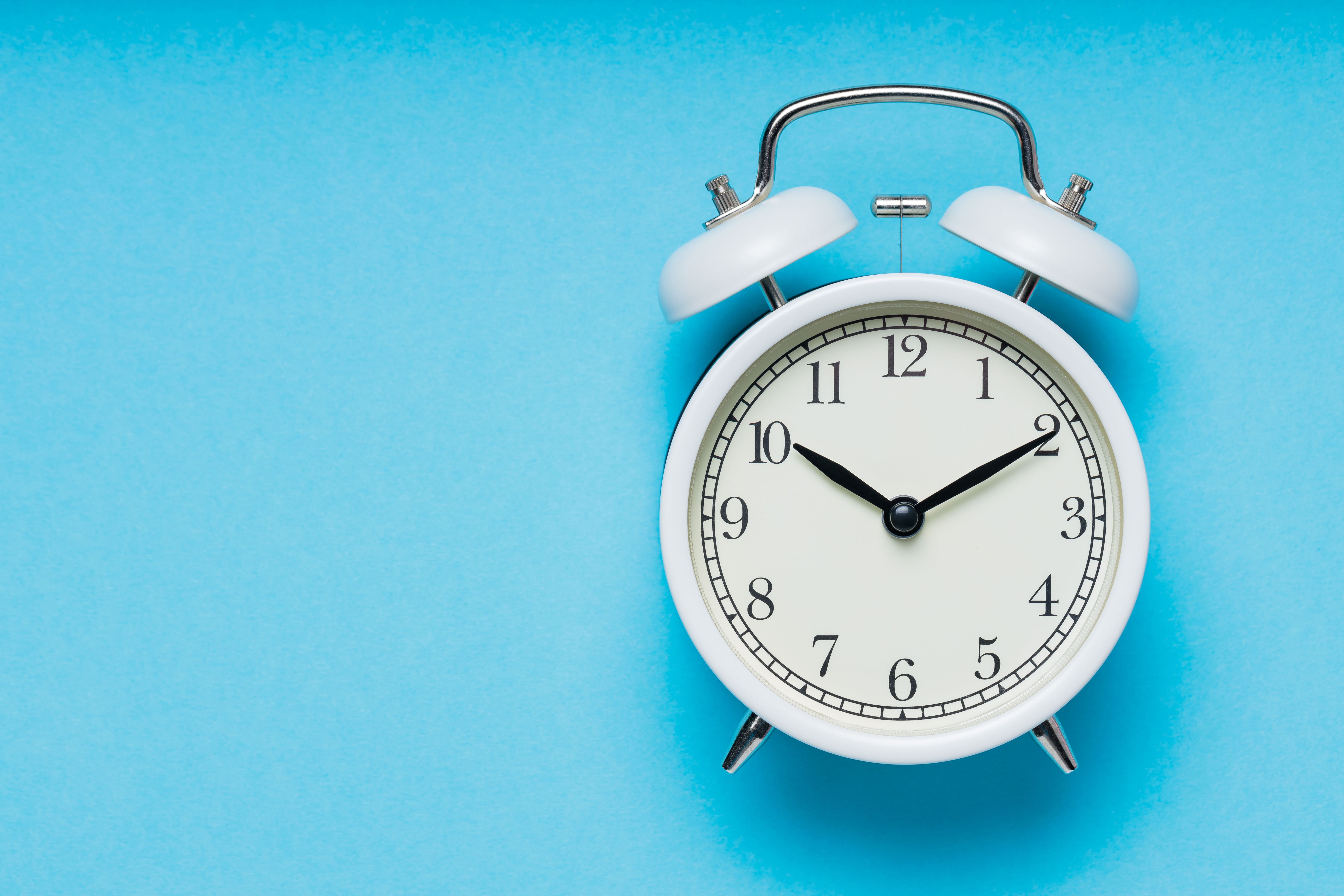 Alarm clock against a blue background