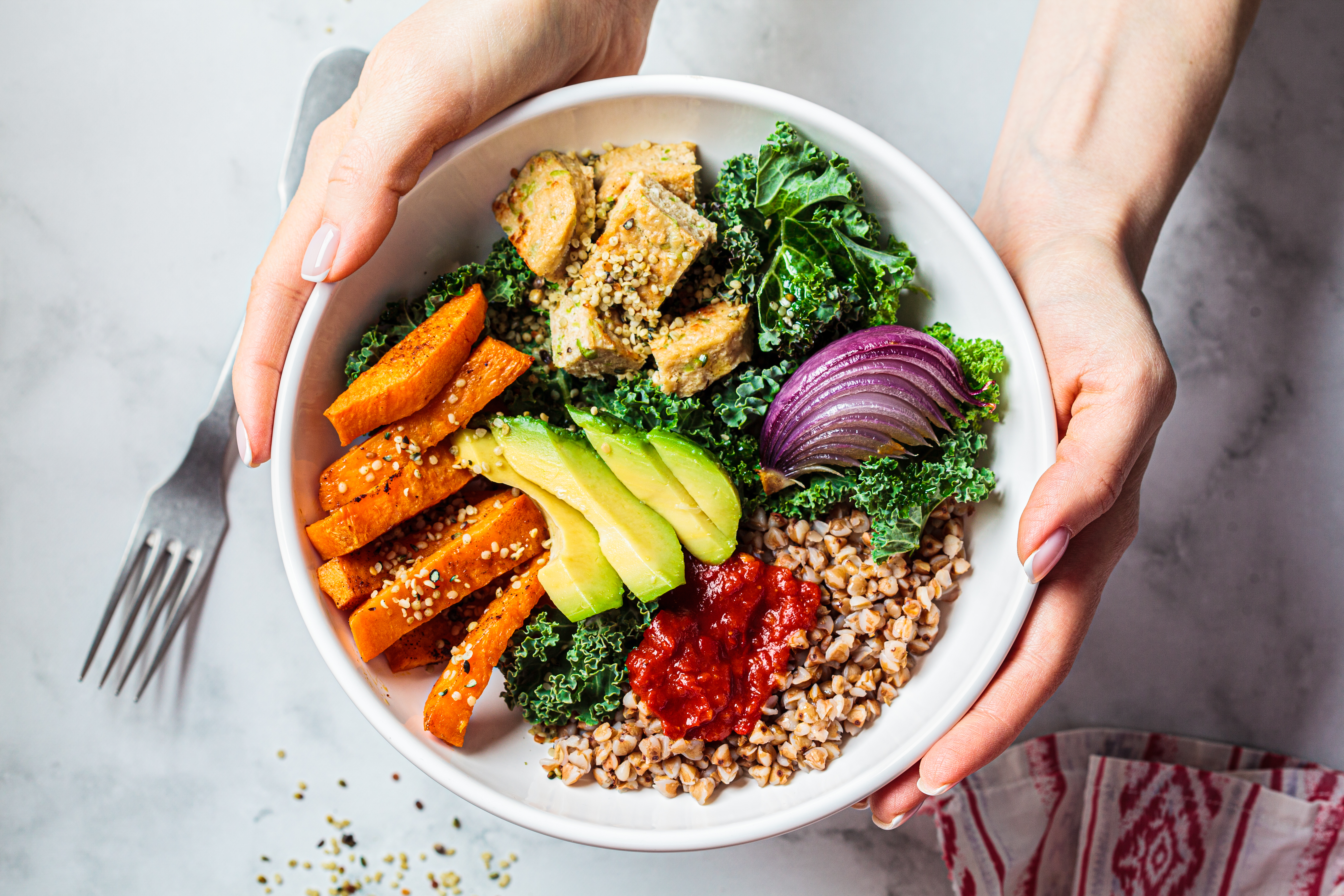 A bowl of fresh foods including avocado and chickpeas