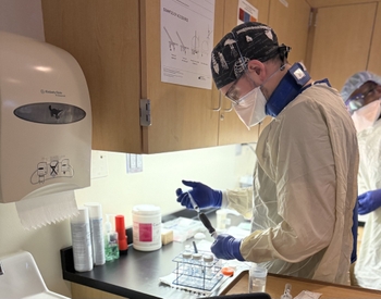 Jeff Civiletti in full personal protective equipment in laboratory setting