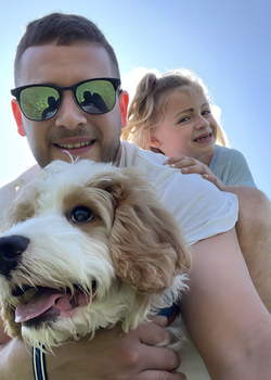 Jeff and Analia taking a selfie with a dog