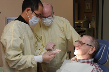 D rSaunders teaching in a clinical environment with a patient and residents 