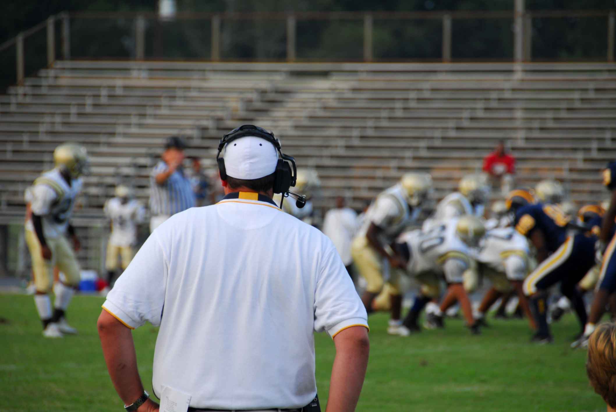 A football coach coaching players