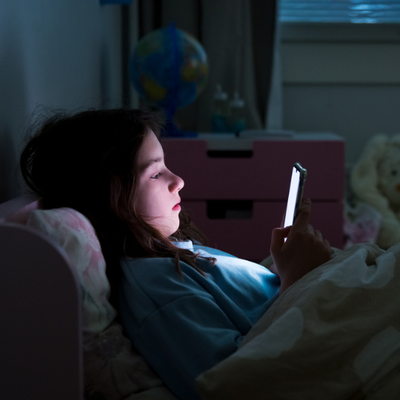young girl on phone at night