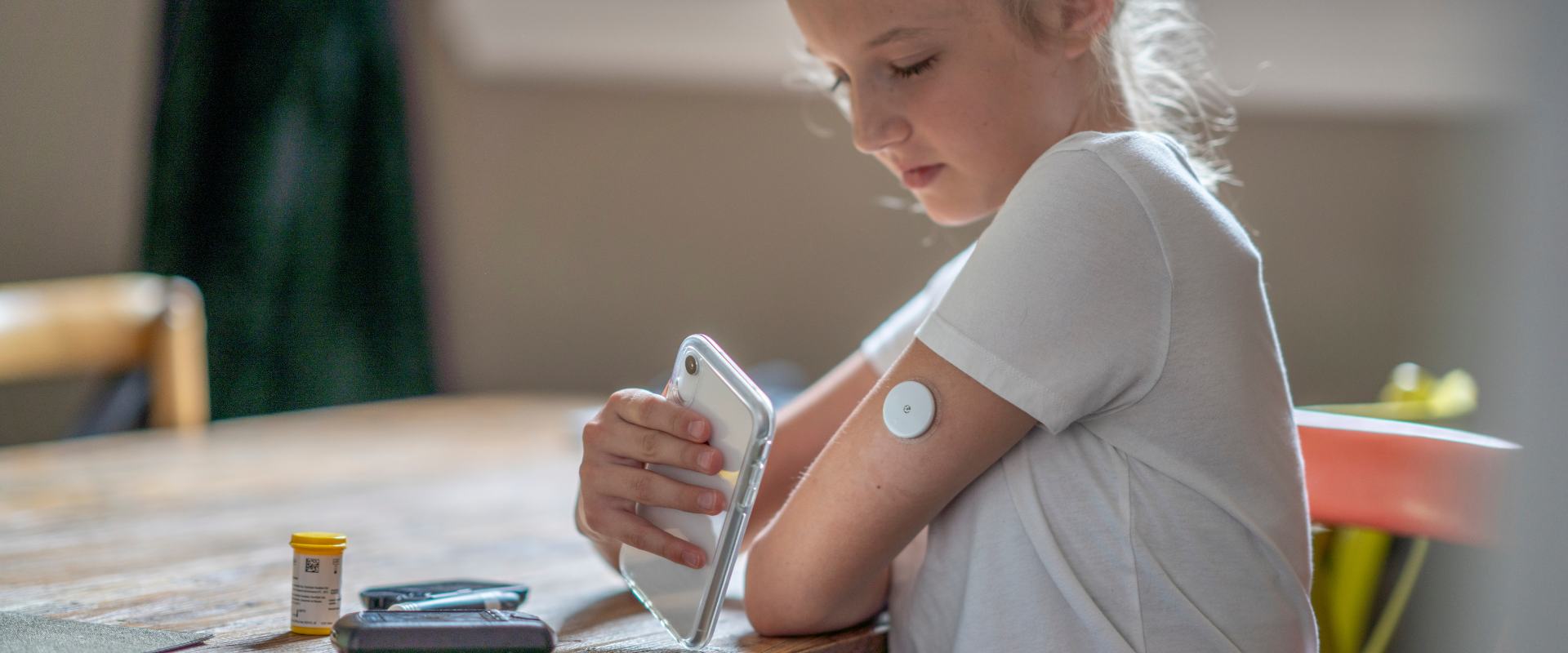 Child with type 1 diabetes monitors insultin
