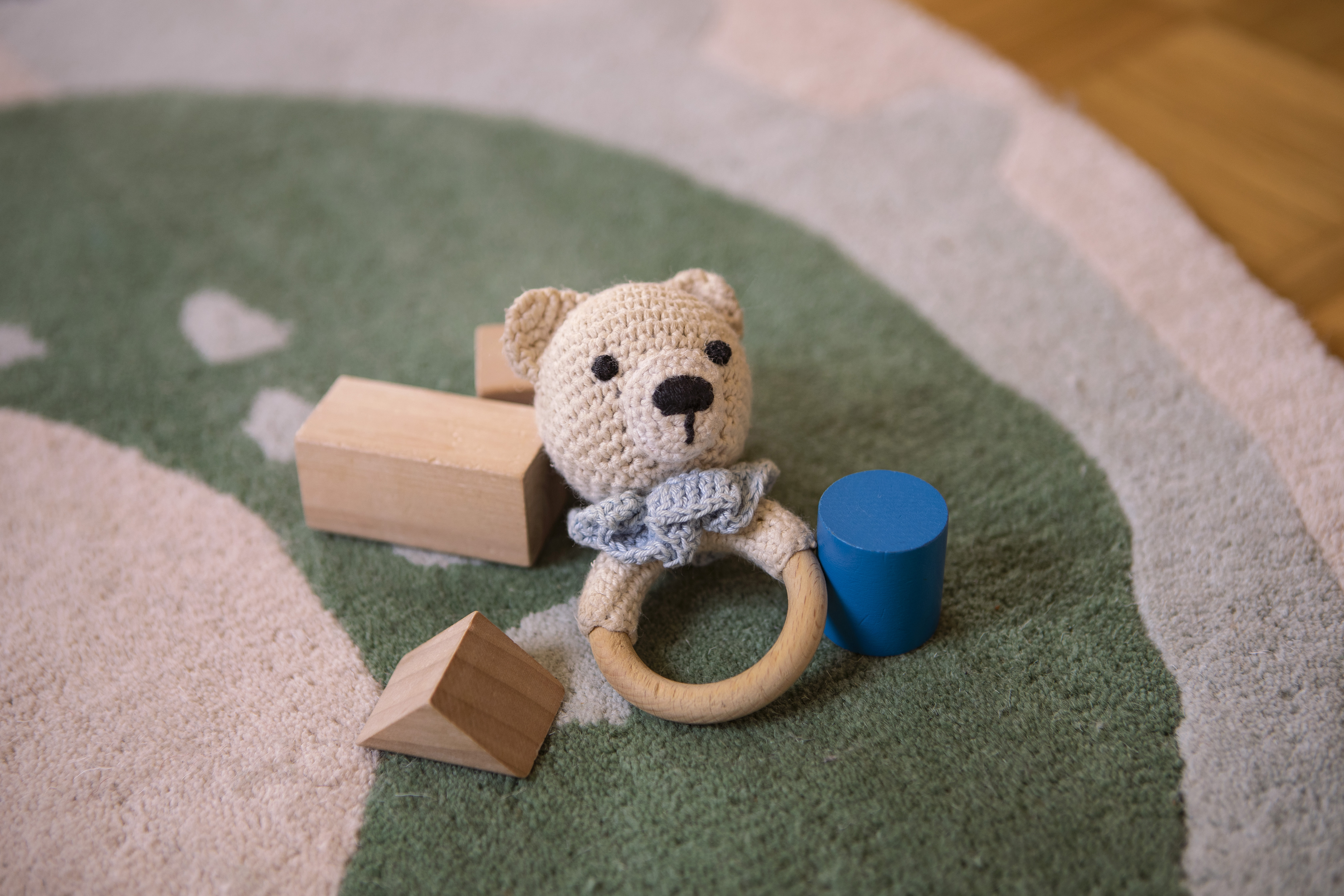 A child's toy lays on a green rug