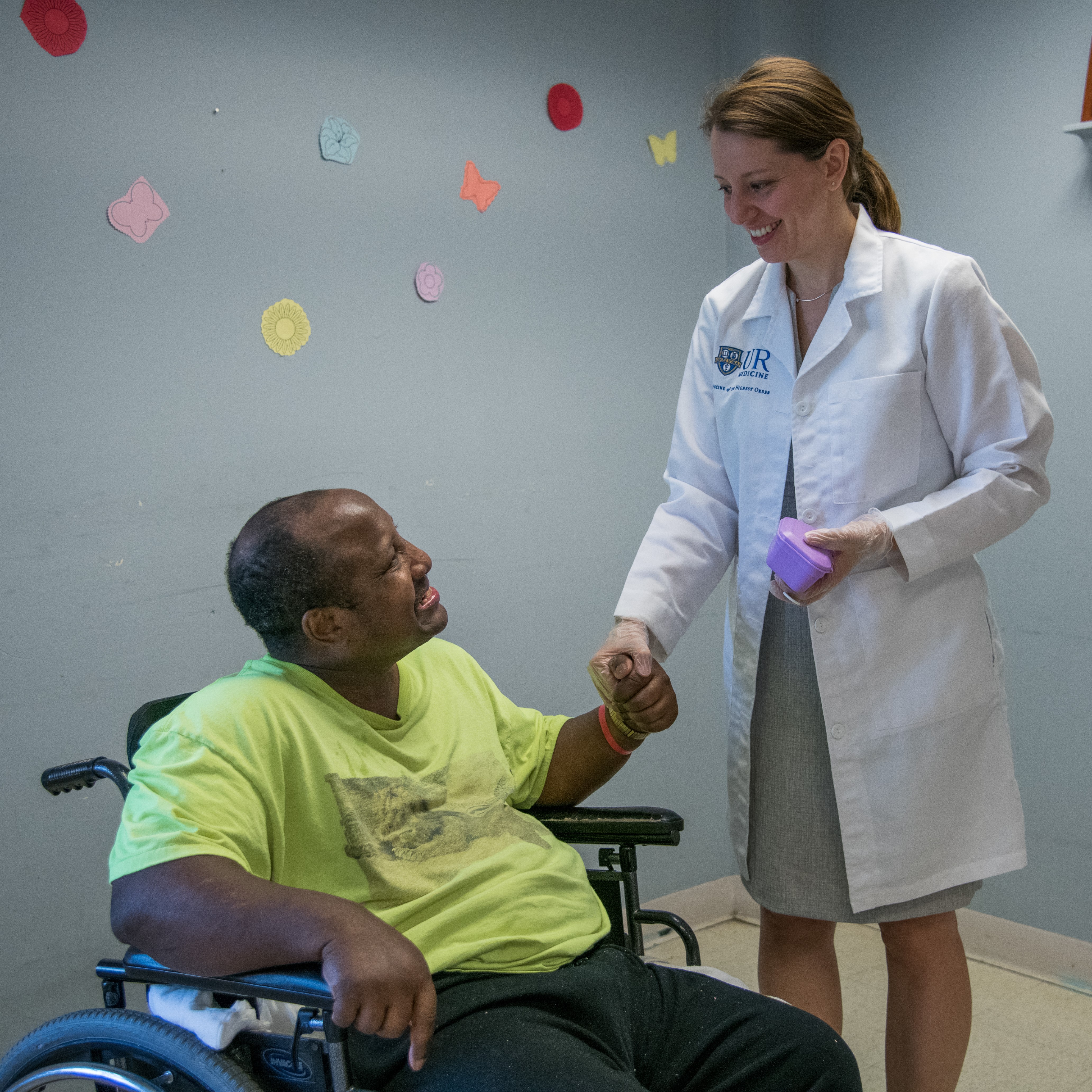 Dr. Planerova with a patient in a wheelchair