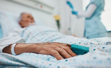 Close up of senior patient with pulse oximeter on finger in the hospital.