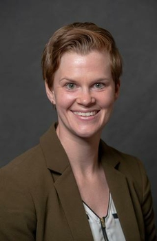 Headshot of Alison Henry; a woman smiling and wearing a brown jacket